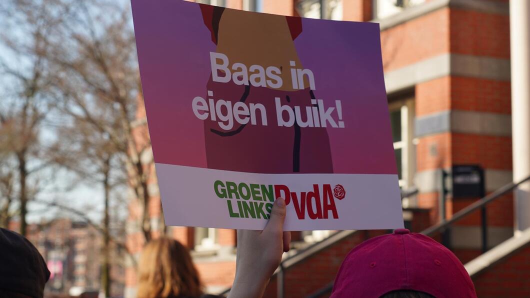 protestbord met 'baas in eigen buik'